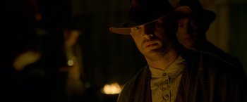 Movie still from “Lawless” (2012), directed by John Hillcoat – A person wearing a hat; Close Up shot, Low angle