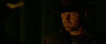 Movie still from “Lawless” (2012), directed by John Hillcoat – A person wearing a hat in the dark; Close Up shot, Low angle
