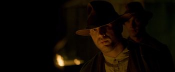 Movie still from “Lawless” (2012), directed by John Hillcoat – A man wearing a hat in the dark; Close Up shot, Low angle