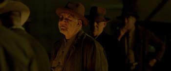 Movie still from “Lawless” (2012), directed by John Hillcoat – A man in a hat and a man in a suit; Close Up shot, Low angle