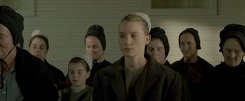 Movie still from “Lawless” (2012), directed by John Hillcoat – A group of people in a room wearing hats and coats; Close Up shot, Low angle