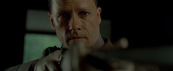 Movie still from “Lawless” (2012), directed by John Hillcoat – A person holding a gun; Close Up shot, Low angle