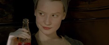 Movie still from “Lawless” (2012), directed by John Hillcoat – A young woman with a head scarf is smiling for the camera; Close Up shot, High angle