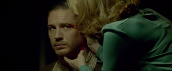 Movie still from “Lawless” (2012), directed by John Hillcoat – A man and a woman looking at each other's face; Close Up shot, Over the shoulder angle