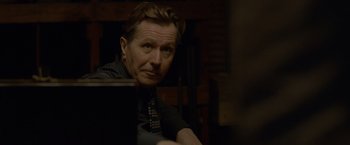 Movie still from “Lawless” (2012), directed by John Hillcoat – A person sitting at a table; Close Up shot, Over the shoulder angle