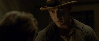 Movie still from “Lawless” (2012), directed by John Hillcoat – A person wearing a hat; Close Up shot, Over the shoulder angle