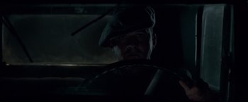 Movie still from “Lawless” (2012), directed by John Hillcoat – A man wearing a hat in a dark room; Close Up shot, Low angle