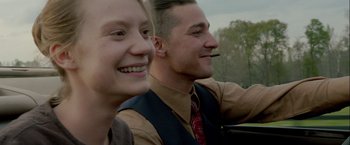 Movie still from “Lawless” (2012), directed by John Hillcoat – A man and a woman are smiling for the camera; Close Up shot, Low angle