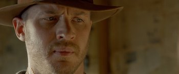 Movie still from “Lawless” (2012), directed by John Hillcoat – A person wearing a hat; Close Up shot, Over the shoulder angle