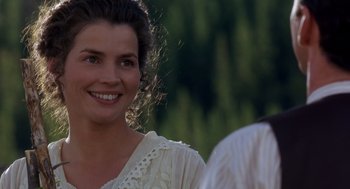 Movie still from “Legends of the Fall” (1994), directed by Edward Zwick – A woman in a white dress smiling for the camera; Close Up shot, Over the shoulder angle