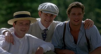Movie still from “Legends of the Fall” (1994), directed by Edward Zwick – A group of men sitting next to each other; Medium shot, Low angle