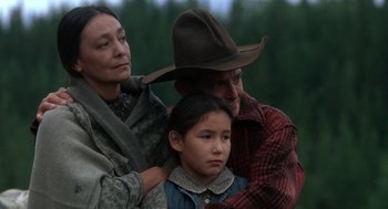 Movie still from “Legends of the Fall” (1994), directed by Edward Zwick – An older man and a younger woman with a young girl; Medium shot, Low angle