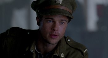 Movie still from “Legends of the Fall” (1994), directed by Edward Zwick – A person wearing a uniform and a hat; Close Up shot, Low angle