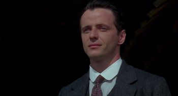 Movie still from “Legends of the Fall” (1994), directed by Edward Zwick – A person wearing a suit and tie; Close Up shot, Low angle
