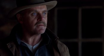 Movie still from “Legends of the Fall” (1994), directed by Edward Zwick – A person wearing a hat; Close Up shot, Over the shoulder angle