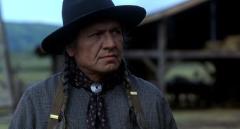 Movie still from “Legends of the Fall” (1994), directed by Edward Zwick – A man in a black hat and a black tie; Close Up shot, Low angle