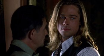 Movie still from “Legends of the Fall” (1994), directed by Edward Zwick – A man with long blonde hair standing next to another man; Close Up shot, Over the shoulder angle