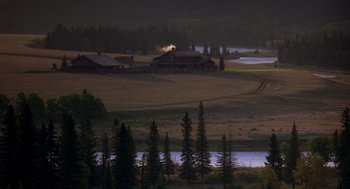 Movie still from “Legends of the Fall” (1994), directed by Edward Zwick – A field that has some trees in the background; Extreme Wide shot, High angle