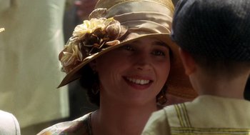 Movie still from “Legends of the Fall” (1994), directed by Edward Zwick – A person wearing a hat with flowers on it; Close Up shot, Over the shoulder angle
