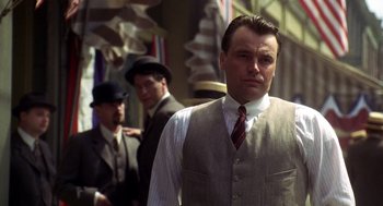 Movie still from “Legends of the Fall” (1994), directed by Edward Zwick – A man in a suit and tie standing next to another man in a suit and tie; Medium shot, Low angle