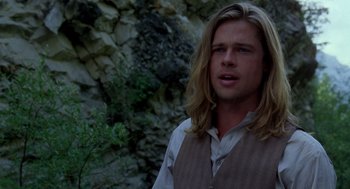 Movie still from “Legends of the Fall” (1994), directed by Edward Zwick – A man with long blonde hair wearing a vest; Close Up shot, Over the shoulder angle