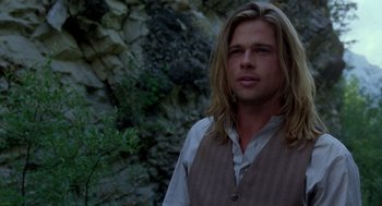 Movie still from “Legends of the Fall” (1994), directed by Edward Zwick – A man with long blonde hair wearing a vest; Close Up shot, Over the shoulder angle