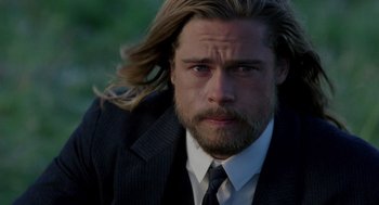 Movie still from “Legends of the Fall” (1994), directed by Edward Zwick – A person wearing a suit and tie; Close Up shot, Over the shoulder angle