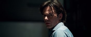Movie still from “Lights Out” (2016), directed by David F. Sandberg – A person wearing a blue shirt; Close Up shot, Over the shoulder angle