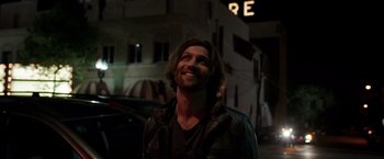 Movie still from “Lights Out” (2016), directed by David F. Sandberg – A man with long brown hair wearing a leather jacket; Close Up shot, Low angle