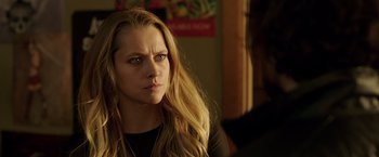 Movie still from “Lights Out” (2016), directed by David F. Sandberg – A young woman with long blonde hair looking at the camera; Close Up shot, Over the shoulder angle
