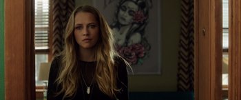 Movie still from “Lights Out” (2016), directed by David F. Sandberg – A beautiful young woman with long blonde hair; Close Up shot, Over the shoulder angle