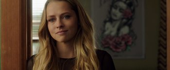 Movie still from “Lights Out” (2016), directed by David F. Sandberg – A beautiful young woman with long blonde hair; Close Up shot, Over the shoulder angle
