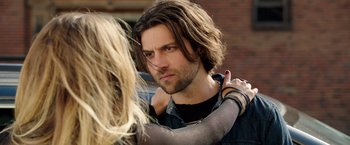 Movie still from “Lights Out” (2016), directed by David F. Sandberg – A man with long black hair and a woman with long blonde hair; Close Up shot, Over the shoulder angle