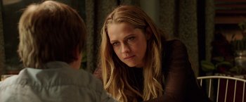 Movie still from “Lights Out” (2016), directed by David F. Sandberg – A young woman looking at a young man in front of a mirror; Close Up shot, Over the shoulder angle