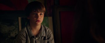 Movie still from “Lights Out” (2016), directed by David F. Sandberg – A young boy is sitting in the dark; Close Up shot, Low angle