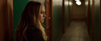 Movie still from “Lights Out” (2016), directed by David F. Sandberg – A young blonde haired woman looking out a window; Close Up shot, Over the shoulder angle