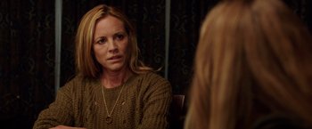 Movie still from “Lights Out” (2016), directed by David F. Sandberg – A woman sitting in front of a mirror looking at the camera; Close Up shot, Over the shoulder angle