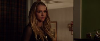 Movie still from “Lights Out” (2016), directed by David F. Sandberg – A beautiful young woman with long , blonde hair; Close Up shot, Over the shoulder angle