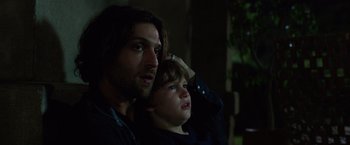 Movie still from “Lights Out” (2016), directed by David F. Sandberg – A man and a boy are looking at the camera; Close Up shot, Low angle