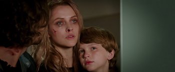 Movie still from “Lights Out” (2016), directed by David F. Sandberg – A woman and a boy are posing for a picture; Close Up shot, Low angle