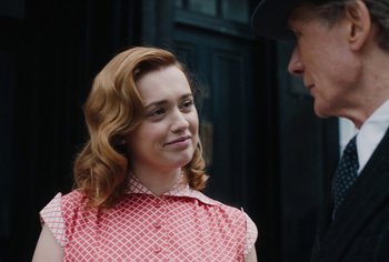 Movie still from “Living” (2022), directed by Oliver Hermanus – A man and a woman talking to each other; Close Up shot, Over the shoulder angle