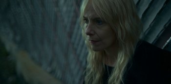 Movie still from “Lost Girls” (2020), directed by Liz Garbus – A woman with long blonde hair looking to her left; Close Up shot, High angle