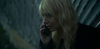 Movie still from “Lost Girls” (2020), directed by Liz Garbus – A woman is talking on a cell phone; Close Up shot, High angle