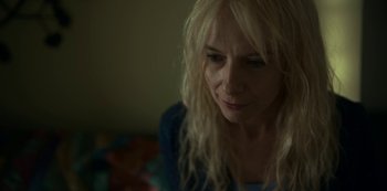 Movie still from “Lost Girls” (2020), directed by Liz Garbus – A woman with blonde hair is looking down at the floor; Close Up shot, High angle