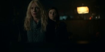 Movie still from “Lost Girls” (2020), directed by Liz Garbus – Two women standing next to each other in a dark room; Close Up shot, Low angle