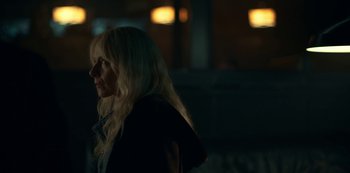 Movie still from “Lost Girls” (2020), directed by Liz Garbus – A woman with long blonde hair standing in the dark; Close Up shot, Over the shoulder angle