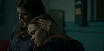 Movie still from “Lost Girls” (2020), directed by Liz Garbus – A woman with her hand on her head and a man with his hand on her shoulder; Close Up shot, Over the shoulder angle
