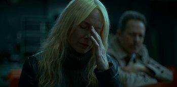 Movie still from “Lost Girls” (2020), directed by Liz Garbus – A woman with blonde hair is holding her head; Close Up shot, High angle