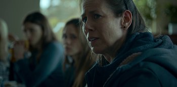 Movie still from “Lost Girls” (2020), directed by Liz Garbus – Two women sitting in front of each other in a room; Close Up shot, Over the shoulder angle