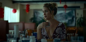 Movie still from “Lost Girls” (2020), directed by Liz Garbus – A woman sitting at a dining room table with her hand on her chin; Close Up shot, Over the shoulder angle